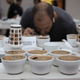 A juror examines coffee at the Best of Panama trial, 2019